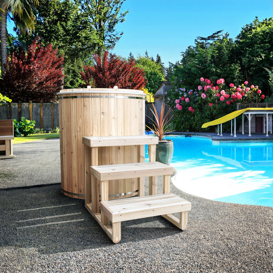 Dundalk Baltic Cedar Cold Plunge Tub with 3-tier cedar steps beside a swimming pool